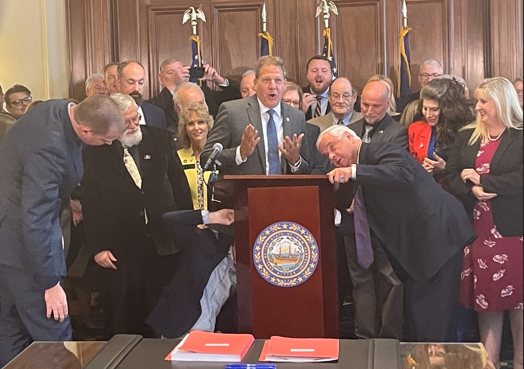 Bipartisan victory lap, plus a broken podium at NH budget signing